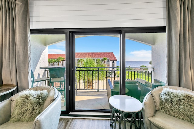 doorway to outside featuring a water view and hardwood / wood-style flooring