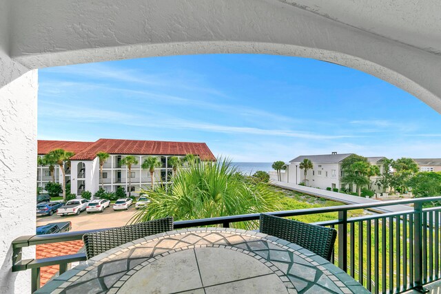 exterior space with a balcony and a water view