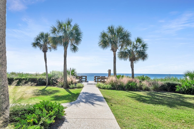 view of home's community featuring a water view and a yard