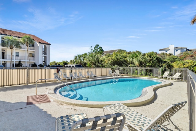 view of swimming pool with a patio area