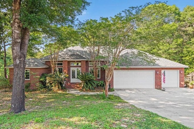 single story home with a front yard and a garage