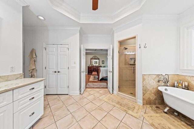 bathroom with tile patterned flooring, vanity, ornamental molding, and plus walk in shower