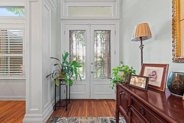 entryway with light wood-type flooring, a wealth of natural light, and french doors