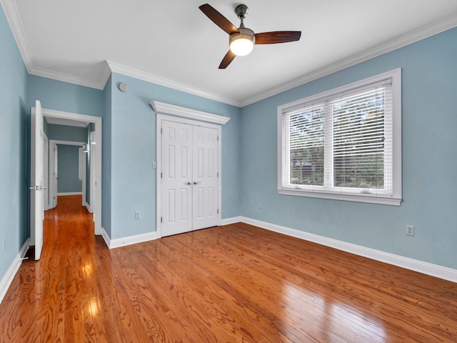 unfurnished bedroom with ceiling fan, light hardwood / wood-style floors, and ornamental molding