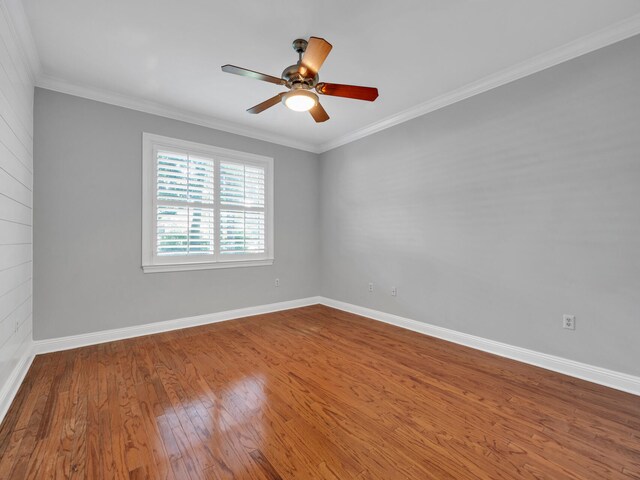 spare room featuring hardwood / wood-style flooring, ceiling fan, and crown molding