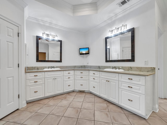 bathroom with a raised ceiling, tile patterned flooring, vanity, and ornamental molding