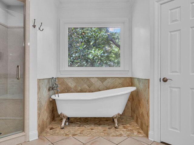 bathroom featuring tile patterned floors, separate shower and tub, and tile walls