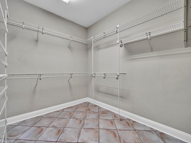 spacious closet featuring tile patterned flooring