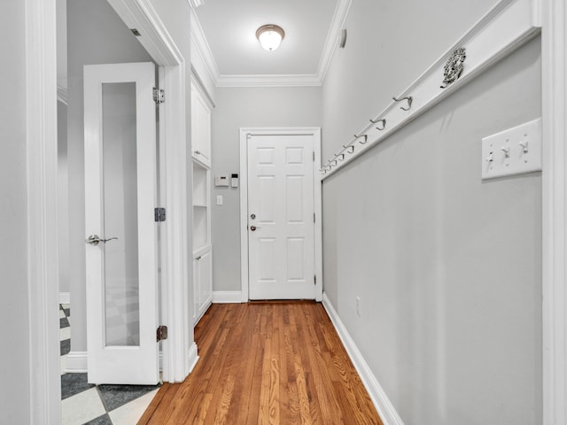 doorway featuring crown molding and hardwood / wood-style floors