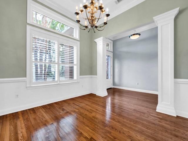 unfurnished dining area with a notable chandelier, plenty of natural light, dark hardwood / wood-style flooring, and ornamental molding