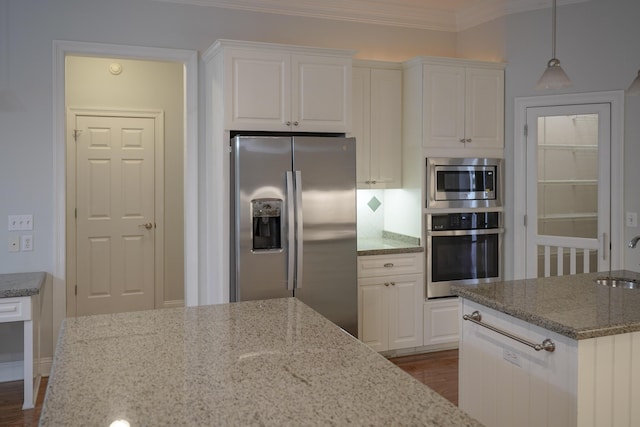 kitchen featuring decorative light fixtures, white cabinetry, light stone countertops, and appliances with stainless steel finishes