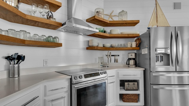 55 Nature Way Unit 100-1, Santa Rosa Beach, FL 32459 - kitchen with appliances with stainless steel finishes, open shelves, wall chimney exhaust hood, white cabinets, and light countertops