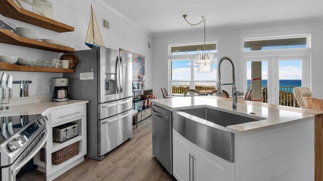 55 Nature Way Unit 100-1, Santa Rosa Beach, FL 32459 - kitchen with a sink, stainless steel appliances, light wood-type flooring, a chandelier, and light countertops