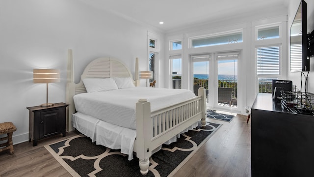 bedroom featuring access to outside and hardwood / wood-style flooring