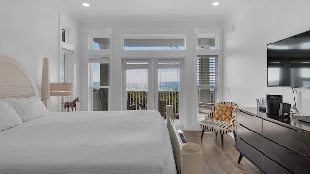 bedroom with access to exterior, light wood-type flooring, and crown molding