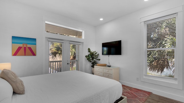 bedroom with wood-type flooring and access to outside