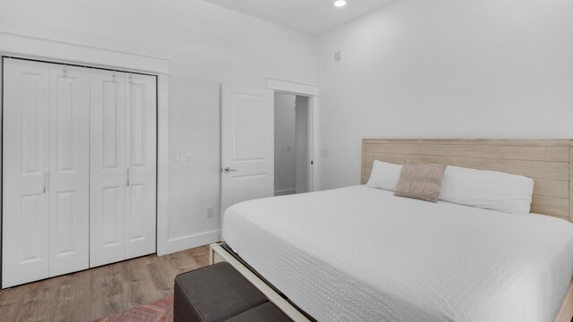 bedroom featuring hardwood / wood-style floors and a closet