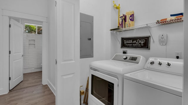 55 Nature Way Unit 100-1, Santa Rosa Beach, FL 32459 - laundry area with washing machine and dryer, electric panel, and light wood-style floors