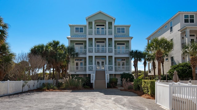 raised beach house with a balcony and french doors