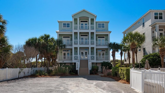 55 Nature Way Unit 100-1, Santa Rosa Beach, FL 32459 - beach home featuring a balcony, french doors, fence, and stairway
