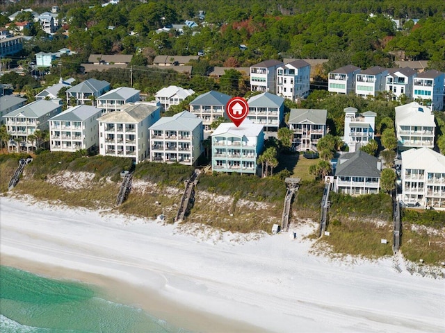 birds eye view of property featuring a water view and a view of the beach