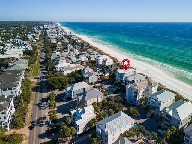 drone / aerial view featuring a water view and a beach view