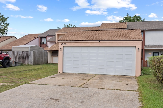 view of front of property with a front yard and a garage