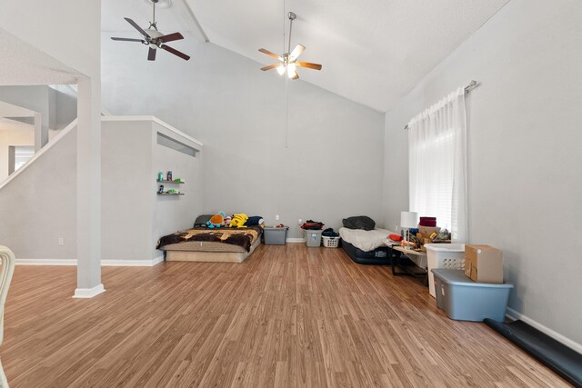 interior space featuring high vaulted ceiling, hardwood / wood-style floors, ceiling fan, and beam ceiling