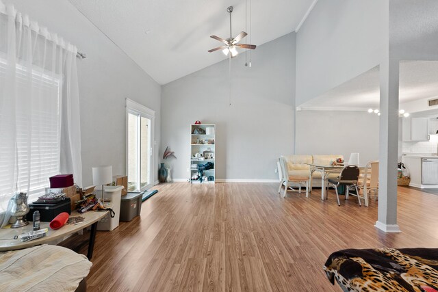 interior space with high vaulted ceiling, hardwood / wood-style floors, and ceiling fan