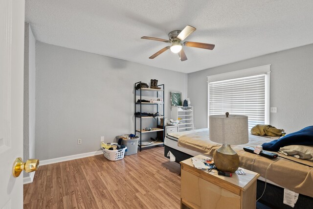 office space with ceiling fan, a textured ceiling, and light hardwood / wood-style flooring