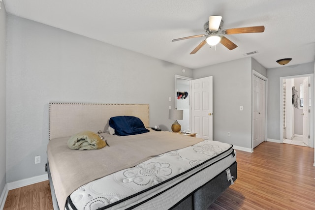1840 E Mallard Dr Apt C, Panama City, FL 32404 - bedroom featuring baseboards, ensuite bath, light wood-style floors, ceiling fan, and visible vents