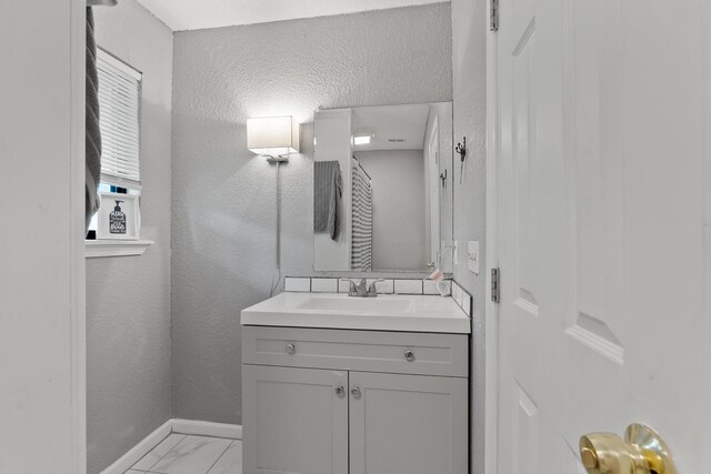 bathroom with a textured ceiling and vanity