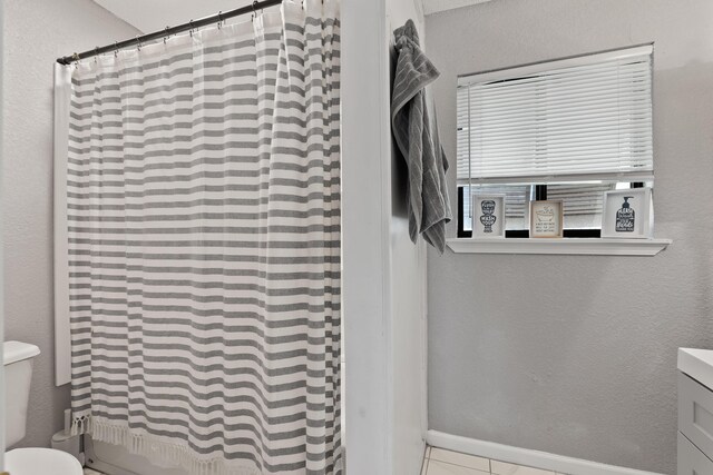 bathroom with tile patterned flooring, toilet, and vanity