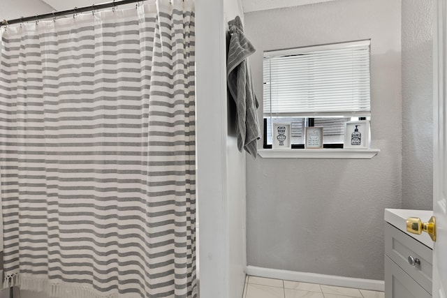 1840 E Mallard Dr Apt C, Panama City, FL 32404 - room details with baseboards, a textured wall, a shower with shower curtain, and vanity