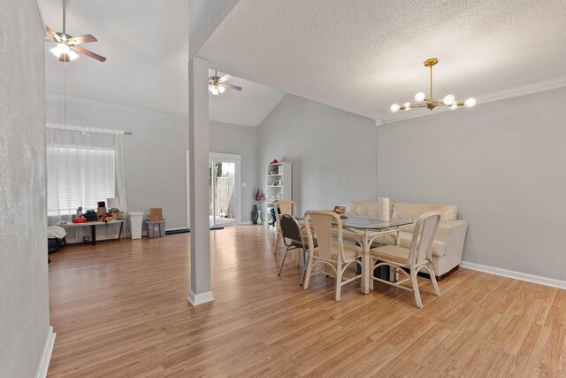 dining room with a textured ceiling, light hardwood / wood-style flooring, ceiling fan with notable chandelier, and high vaulted ceiling