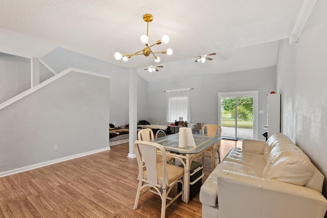 1840 E Mallard Dr Apt C, Panama City, FL 32404 - dining space featuring a textured ceiling, light wood-style flooring, baseboards, ceiling fan with notable chandelier, and vaulted ceiling