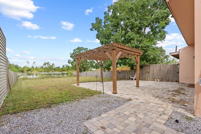 view of patio featuring a pergola and a water view