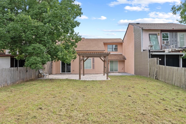 1840 E Mallard Dr Apt C, Panama City, FL 32404 - back of house with a fenced backyard, a pergola, a yard, and a patio