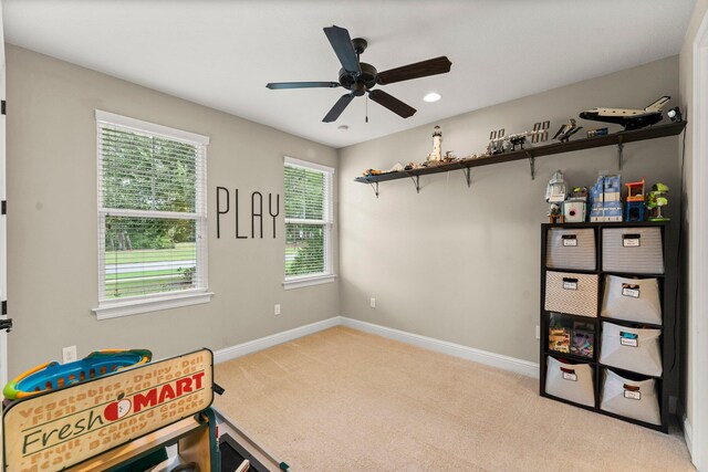 interior space featuring light colored carpet and ceiling fan