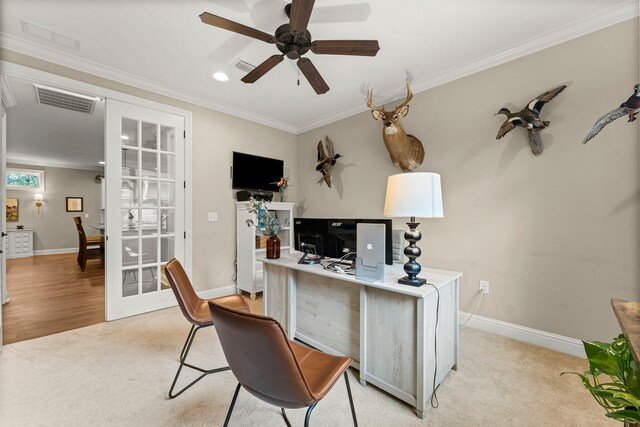 office space with crown molding, light colored carpet, and ceiling fan