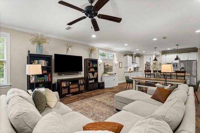 living room featuring crown molding, hardwood / wood-style flooring, plenty of natural light, and ceiling fan