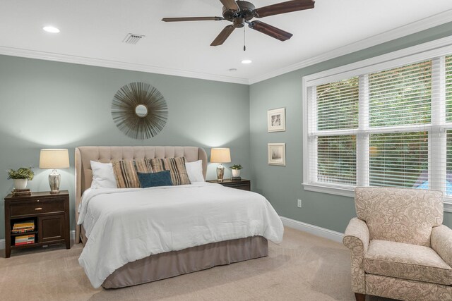 bedroom with crown molding, light colored carpet, and ceiling fan