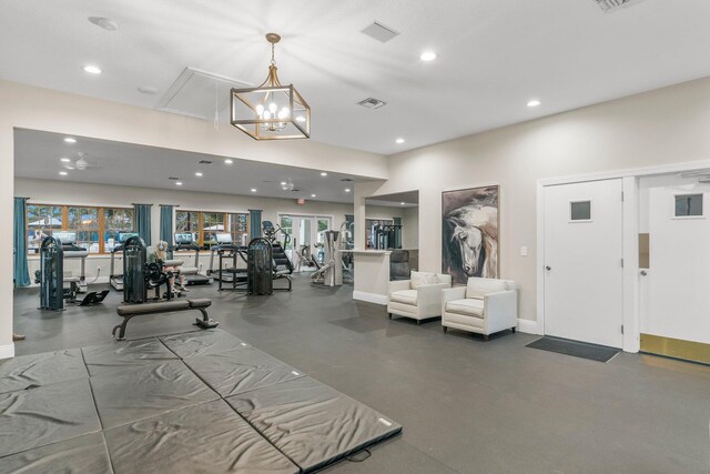 workout area with an inviting chandelier