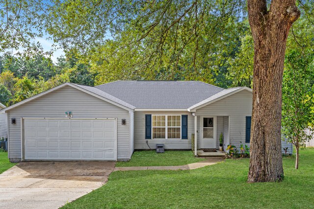 ranch-style house featuring a garage and a front lawn