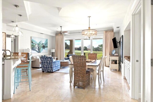 dining area with crown molding and ceiling fan with notable chandelier