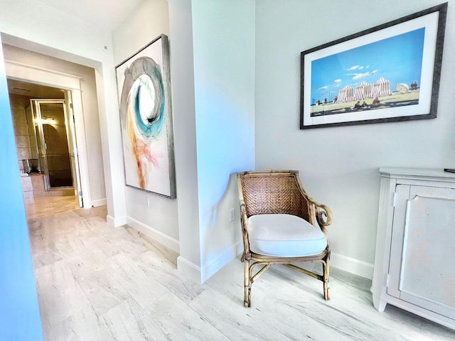 living area featuring baseboards