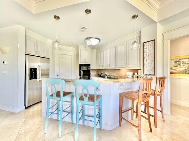 kitchen featuring visible vents, light stone counters, decorative backsplash, a peninsula, and black appliances