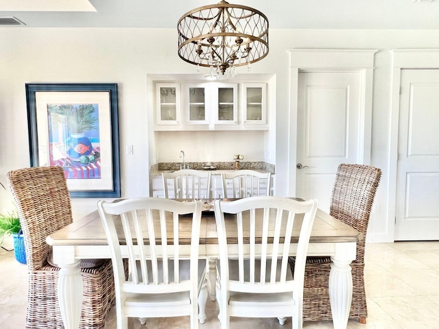 dining room with light tile patterned floors, visible vents, and an inviting chandelier