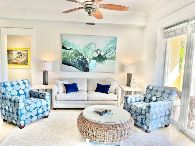 living area featuring visible vents, ceiling fan, and crown molding