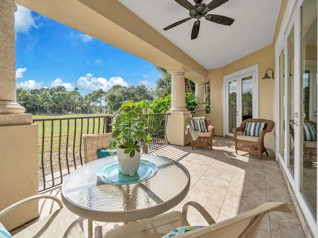 balcony with ceiling fan and french doors